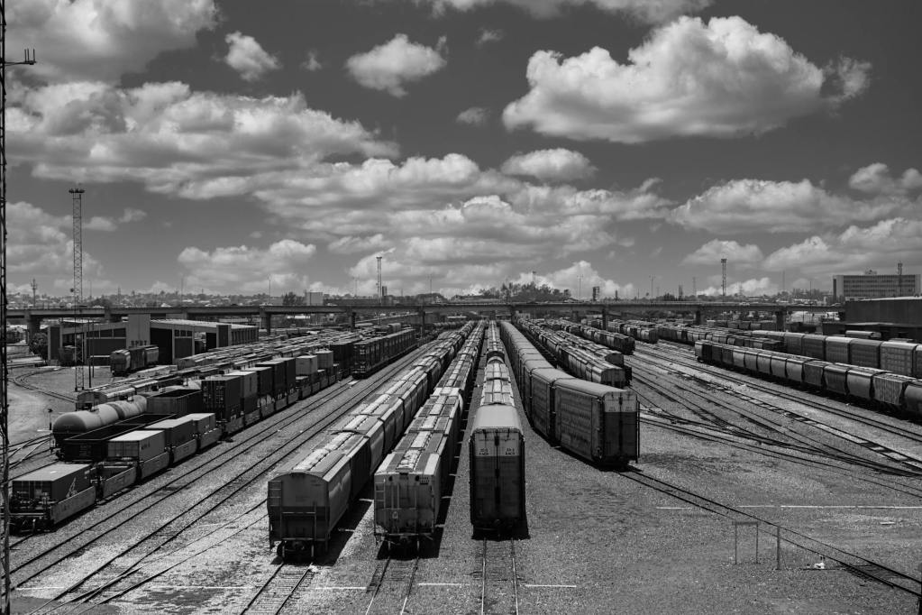 trains in city in black and white